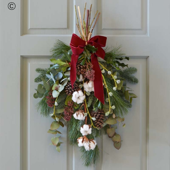 fresh blooms and foliage with shades of red and green, peach and cream highlights and pops of burgundy and cerise